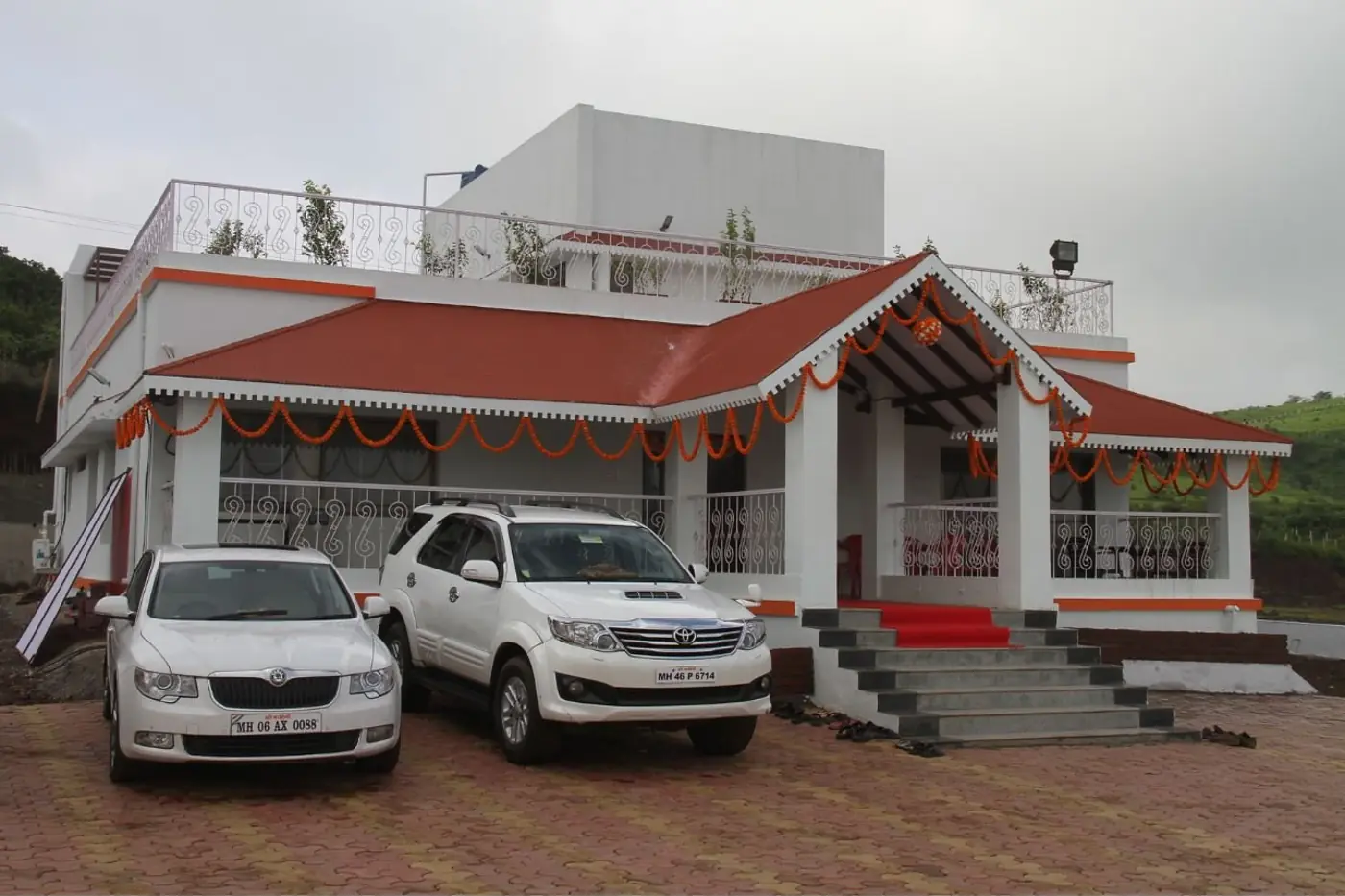 RK Project bungalow front elevation with porch and landscaped drive