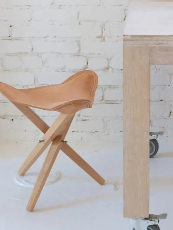 Console and stool detail against a whitewashed brick wall