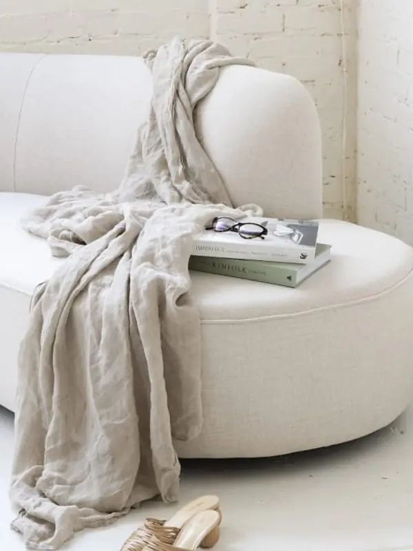 Bedroom seating detail with linen and boucle upholstery